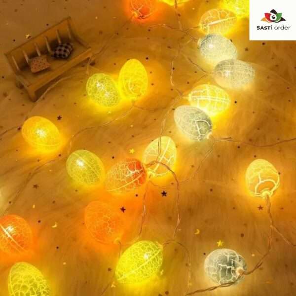 A set of Cracked Egg String Lights, featuring colorful cracked egg-shaped bulbs strung along a flexible wire. The lights emit a warm glow, creating a cheerful and inviting ambiance. Perfect for Easter celebrations, spring decor, or festive gatherings, these whimsical lights add a playful touch to any indoor or outdoor setting.