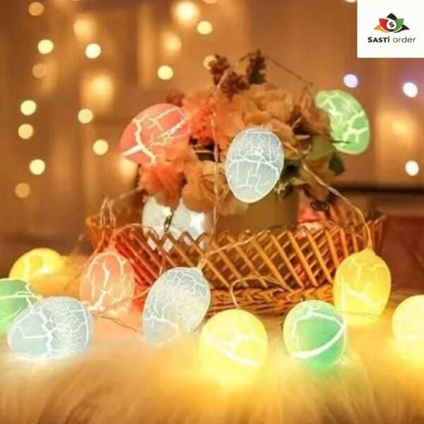 A set of Cracked Egg String Lights, featuring colorful cracked egg-shaped bulbs strung along a flexible wire. The lights emit a warm glow, creating a cheerful and inviting ambiance. Perfect for Easter celebrations, spring decor, or festive gatherings, these whimsical lights add a playful touch to any indoor or outdoor setting.