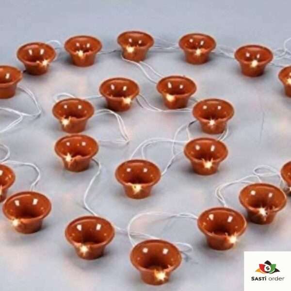 A Diya Light Toran featuring a traditional garland design adorned with glowing diya-shaped lights. The toran is beautifully crafted to hang over doorways or windows, emitting a soft, warm glow. Perfect for Diwali or festive occasions, it adds an elegant and welcoming touch to any home decor, both indoors and outdoors.