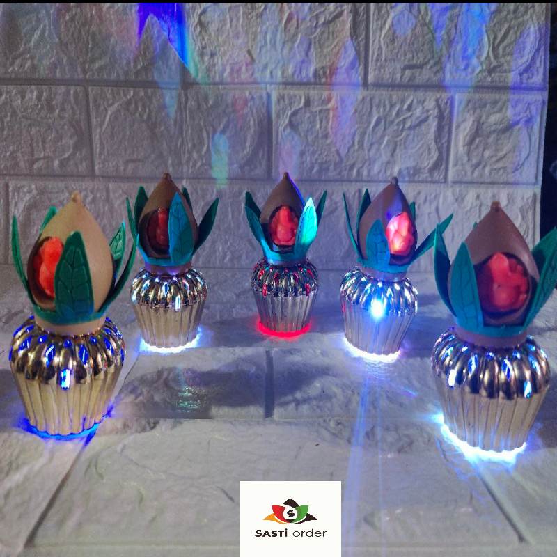 A beautifully designed LED Kalash with Meena Leaf and Ganesh Ji Face, featuring intricate Meena-style leaves and a serene Ganesh Ji face on the front. The Kalash is illuminated by soft LED lights, creating a warm and spiritual glow. Perfect for religious ceremonies, pooja decor, and festive occasions, symbolizing prosperity and good fortune.