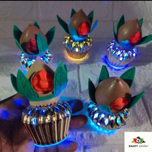 A beautifully designed LED Kalash with Meena Leaf and Ganesh Ji Face, featuring intricate Meena-style leaves and a serene Ganesh Ji face on the front. The Kalash is illuminated by soft LED lights, creating a warm and spiritual glow. Perfect for religious ceremonies, pooja decor, and festive occasions, symbolizing prosperity and good fortune.