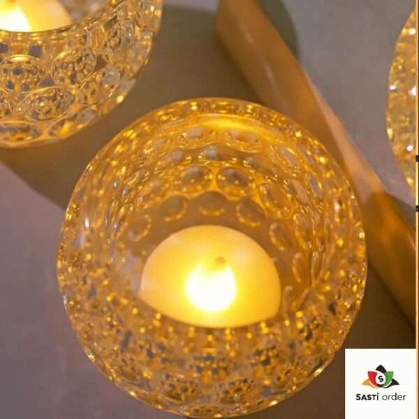 A sleek, honeycomb-patterned clear plastic LED candle holder that mimics the look of crystal, designed to beautifully refract light from flameless candles, adding a modern and elegant touch to any room or event.