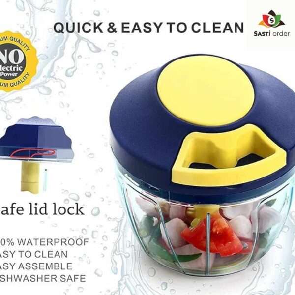 A Manual Vegetable Fruit Onion Chopper with a clear bowl, stainless steel blades, and a pull-cord mechanism, placed on a kitchen counter with chopped onions and vegetables nearby.
