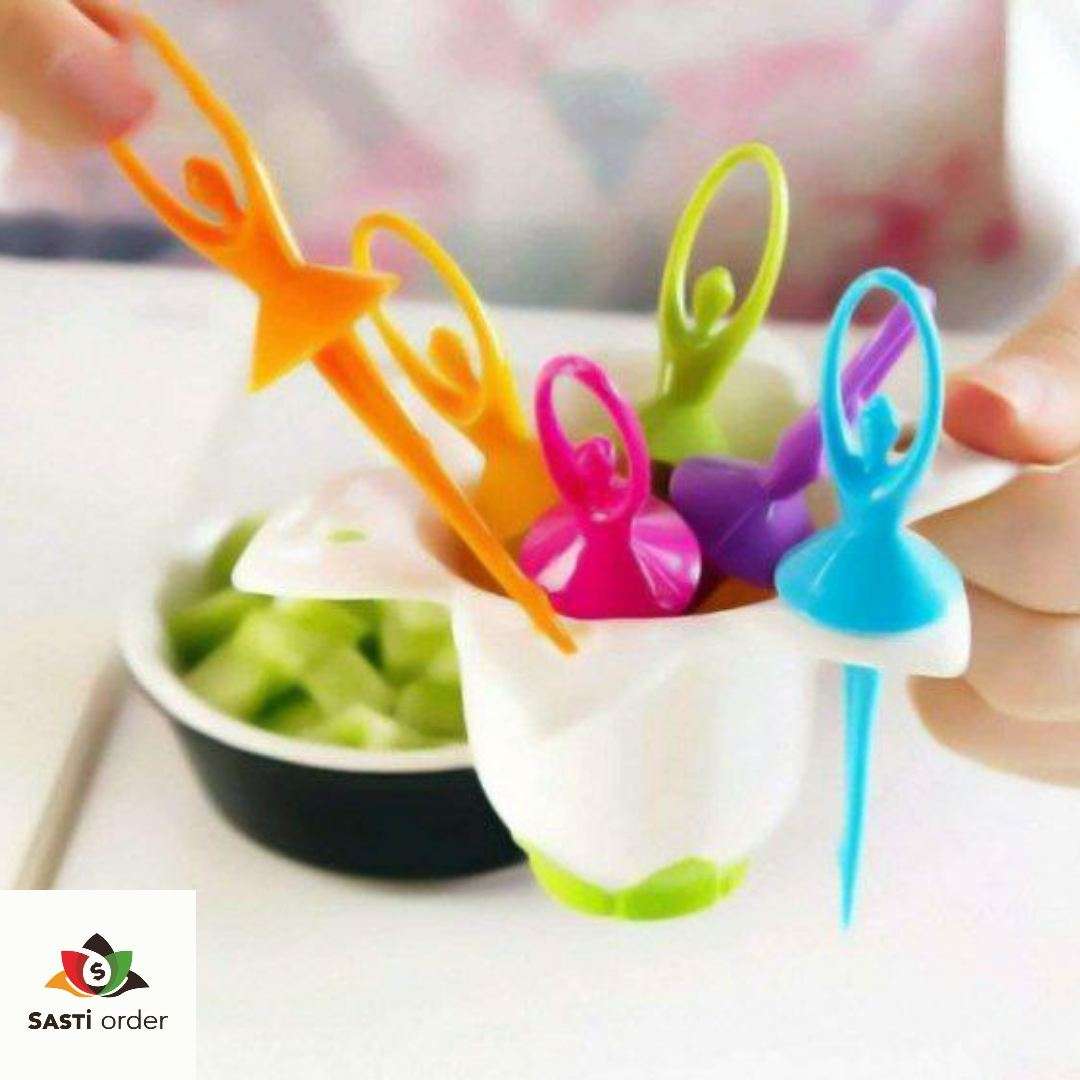 A set of Multicolour Fiber Dancing Doll Fruit Forks, showcasing vibrant colors and playful dancing doll designs, arranged on a colorful tablecloth with fruit and snacks in the background.
