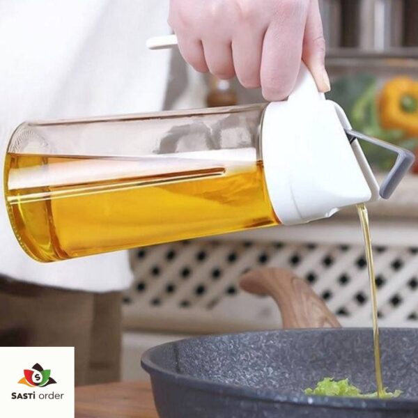 Auto Flip Cooking Oil Bottle, 500ML, with a transparent body and automatic flip top mechanism, displayed on a kitchen countertop.