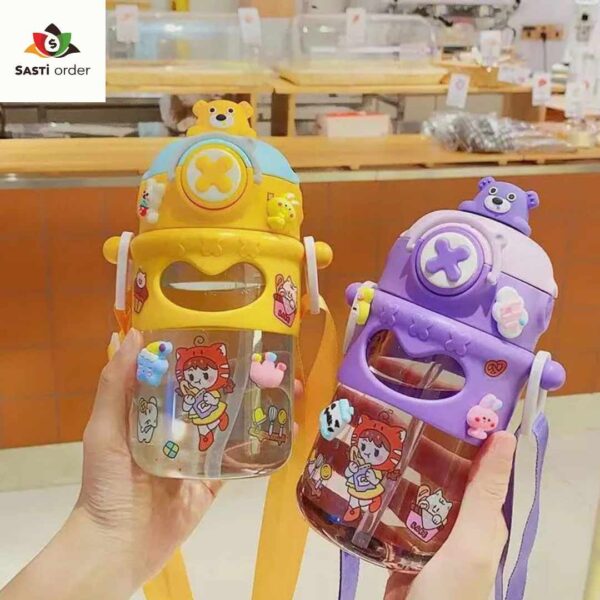 "Cute cartoon unisex kids water bottle with vibrant designs, displayed on a child's desk among school supplies."